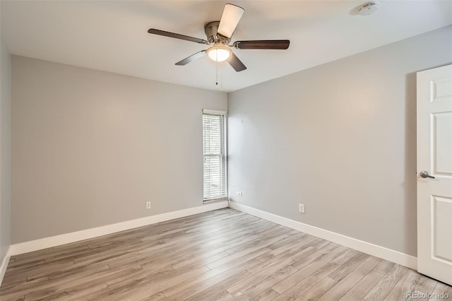 unfurnished room with light wood-style flooring, baseboards, a smoke detector, and ceiling fan