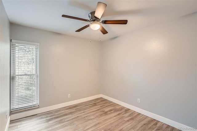 empty room featuring light wood-style floors, baseboards, and a ceiling fan