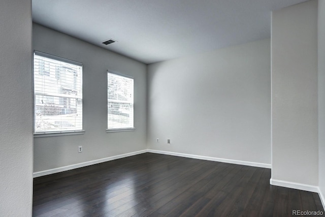 empty room featuring dark hardwood / wood-style flooring