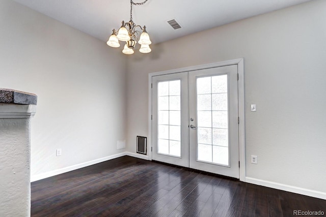 doorway with hardwood / wood-style flooring, plenty of natural light, french doors, and a chandelier