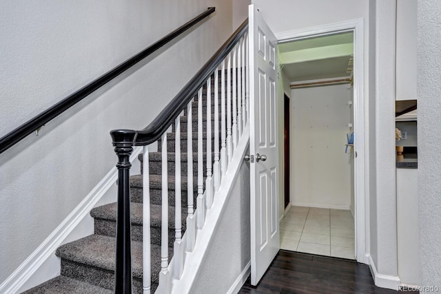 staircase with hardwood / wood-style flooring