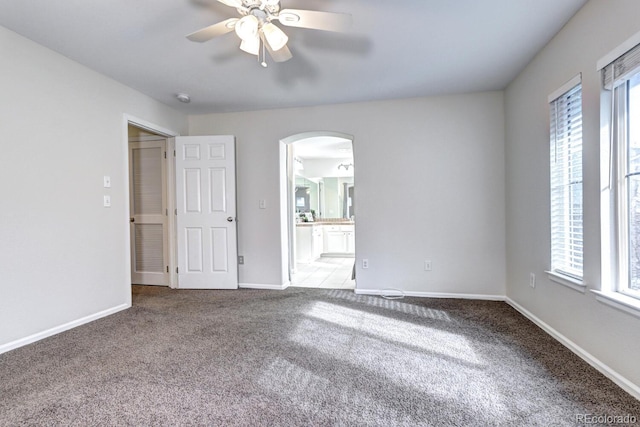 empty room featuring light colored carpet and ceiling fan