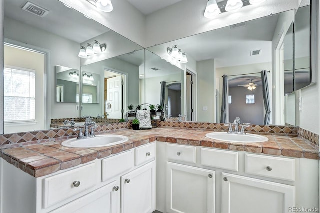 bathroom featuring ceiling fan and vanity