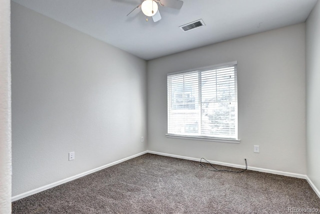 carpeted empty room featuring ceiling fan