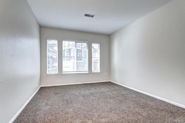 unfurnished room featuring carpet