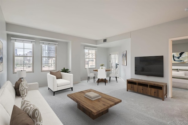 carpeted living area featuring baseboards