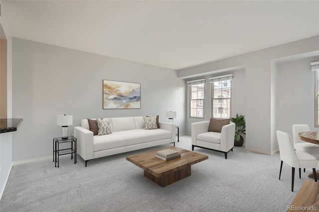 living room featuring carpet and baseboards