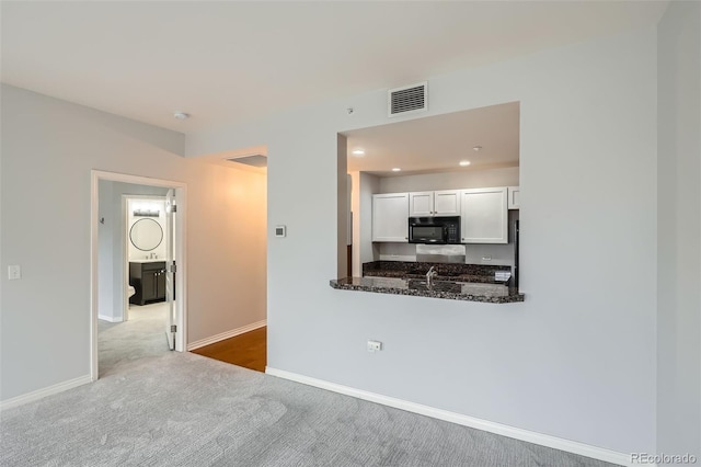 unfurnished living room featuring carpet flooring, baseboards, and recessed lighting