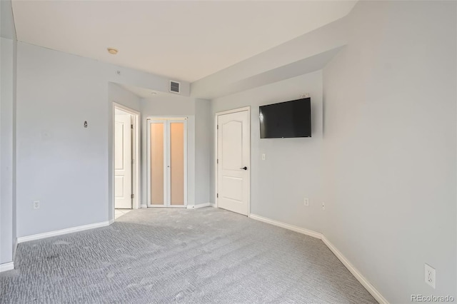 unfurnished room with baseboards and carpet floors