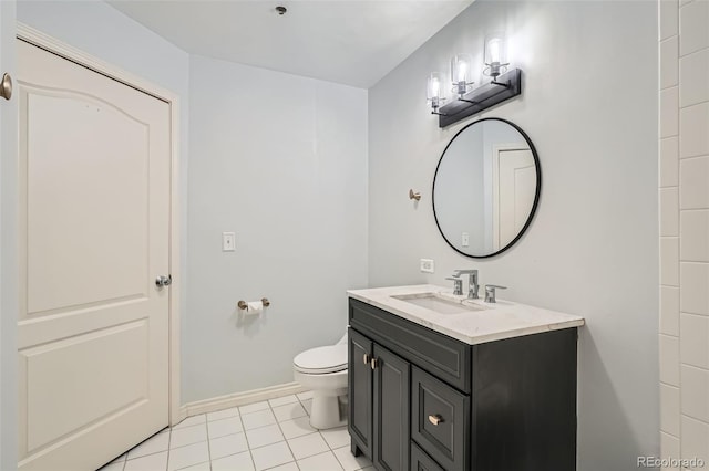 bathroom featuring vanity, tile patterned floors, toilet, and baseboards