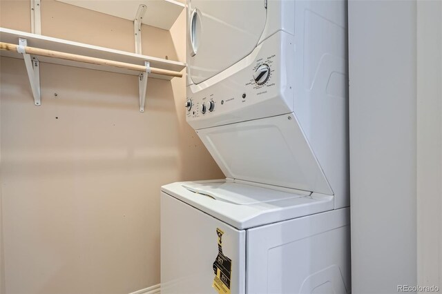 laundry room with stacked washer / dryer