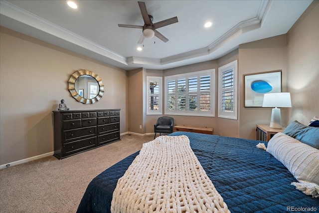 bedroom featuring ceiling fan, carpet floors, ornamental molding, and a tray ceiling