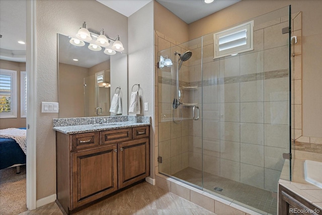 bathroom with vanity and a shower with door