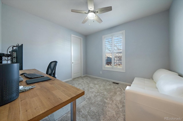 home office with light carpet and ceiling fan