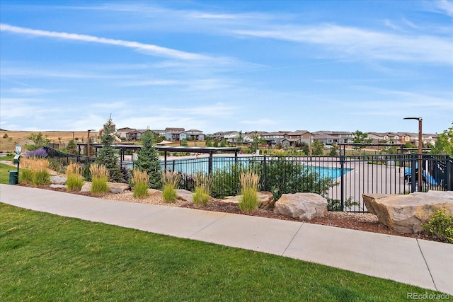 view of pool featuring a yard