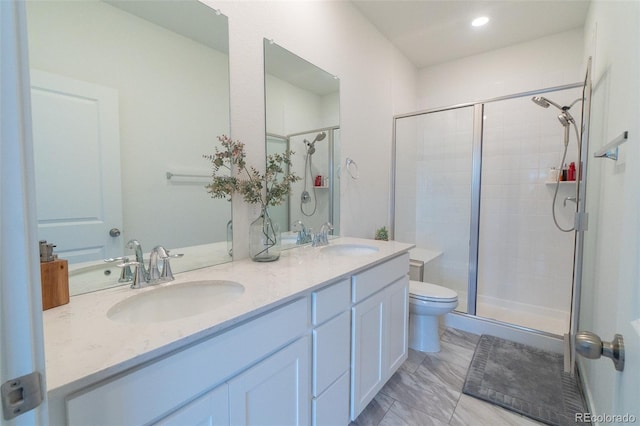 9152 Gladiola Way Unit E, Arvada, CO 80005 - full bath with a stall shower, marble finish floors, toilet, double vanity, and recessed lighting