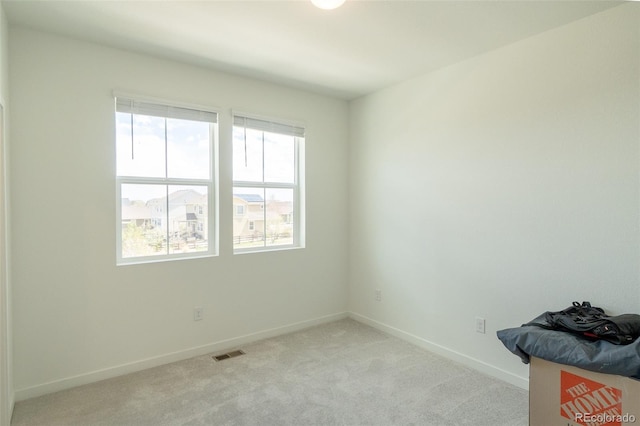 9152 Gladiola Way Unit E, Arvada, CO 80005 - spare room with healthy amount of natural light, light colored carpet, and baseboards