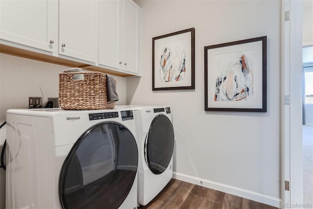 clothes washing area with cabinets, washer and dryer, and dark hardwood / wood-style flooring