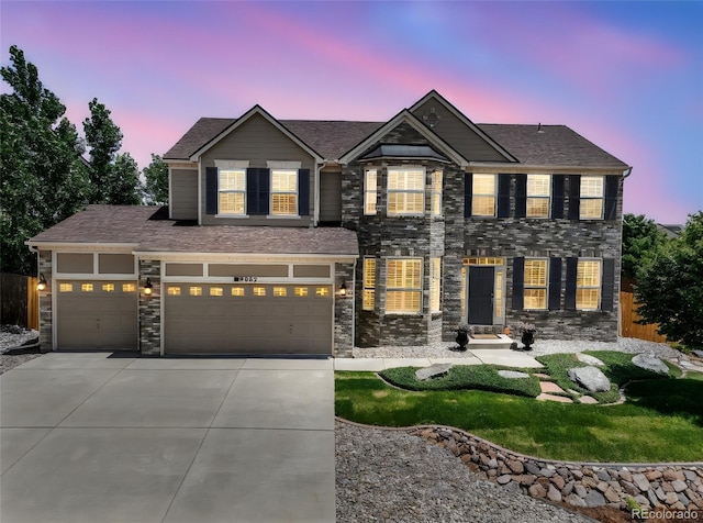 9005 Royal Melbourne Cir, Peyton, CO 80831 - view of front facade with driveway, stone siding, and a garage
