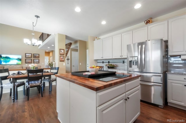 9005 Royal Melbourne Cir, Peyton, CO 80831 - kitchen with wood counters, stainless steel fridge with ice dispenser, a chandelier, white cabinets, and recessed lighting