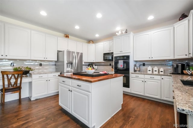 9005 Royal Melbourne Cir, Peyton, CO 80831 - kitchen featuring black appliances, butcher block counters, decorative backsplash, white cabinetry, and recessed lighting