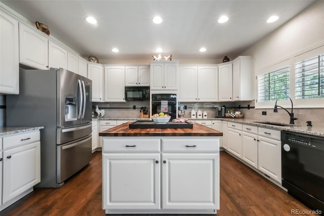 9005 Royal Melbourne Cir, Peyton, CO 80831 - kitchen featuring black appliances, butcher block countertops, a kitchen island, white cabinets, and recessed lighting