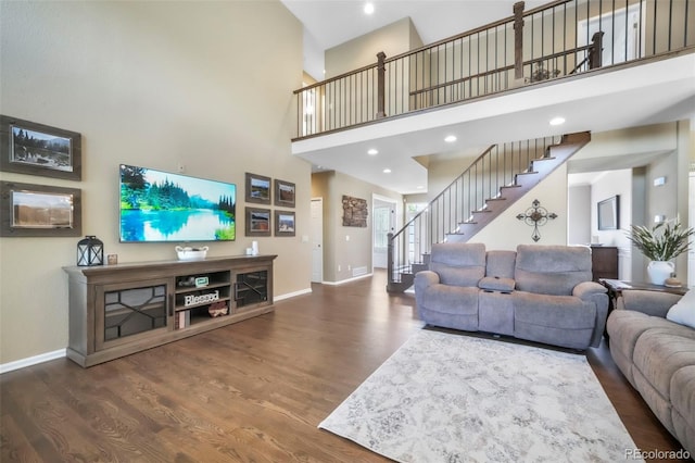 9005 Royal Melbourne Cir, Peyton, CO 80831 - living room featuring stairway, wood finished floors, a towering ceiling, and recessed lighting