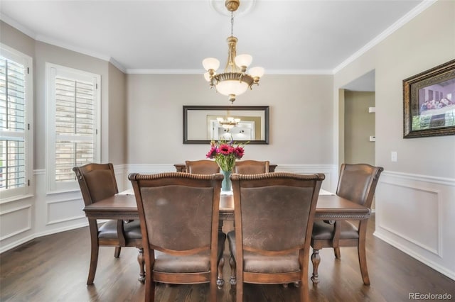 9005 Royal Melbourne Cir, Peyton, CO 80831 - dining space with a chandelier, ornamental molding, dark wood-style flooring, a wainscoted wall, and a decorative wall