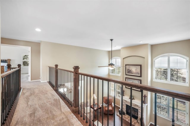 9005 Royal Melbourne Cir, Peyton, CO 80831 - corridor featuring an upstairs landing, healthy amount of natural light, and recessed lighting