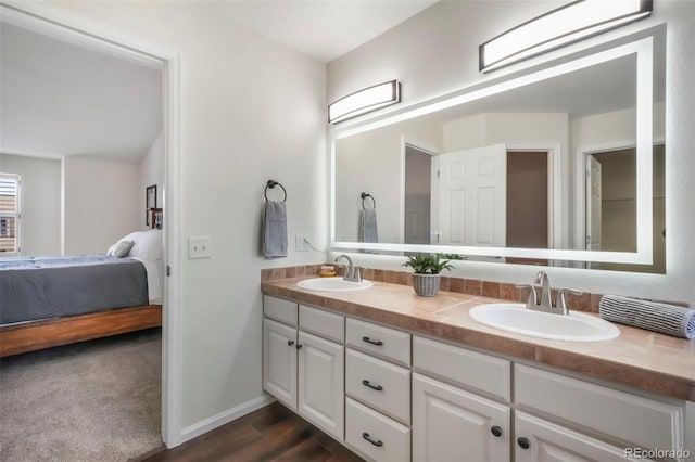 9005 Royal Melbourne Cir, Peyton, CO 80831 - ensuite bathroom with double vanity and wood finished floors