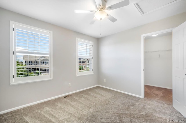 9005 Royal Melbourne Cir, Peyton, CO 80831 - unfurnished bedroom featuring carpet flooring, a spacious closet, attic access, and ceiling fan