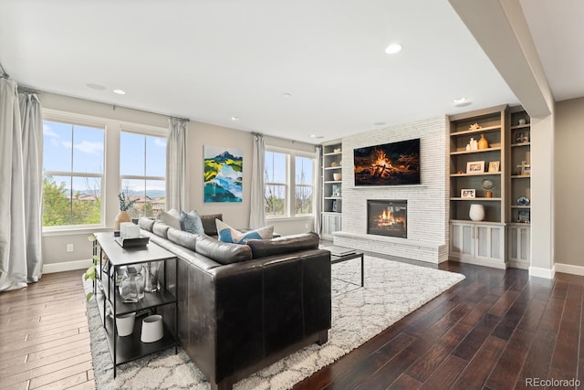 237 Maplehurst Dr, Highlands Ranch, CO 80126 - living room with baseboards, dark wood-style flooring, plenty of natural light, a brick fireplace, and recessed lighting