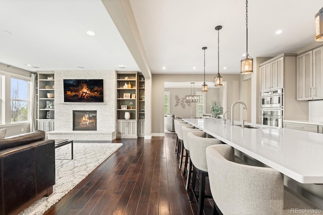 237 Maplehurst Dr, Highlands Ranch, CO 80126 - kitchen with a sink, open floor plan, a kitchen breakfast bar, and recessed lighting