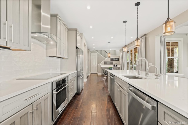 237 Maplehurst Dr, Highlands Ranch, CO 80126 - kitchen featuring appliances with stainless steel finishes, wall chimney exhaust hood, a sink, light countertops, and recessed lighting
