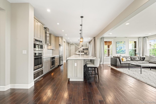237 Maplehurst Dr, Highlands Ranch, CO 80126 - kitchen with open floor plan, a breakfast bar, a sink, cream cabinets, and a warming drawer