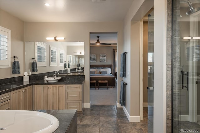 237 Maplehurst Dr, Highlands Ranch, CO 80126 - ensuite bathroom featuring vanity, ceiling fan, a tub, a shower with door, and baseboards