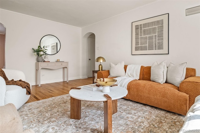 1410 Vine St Unit 3, Denver, CO 80206 - living room featuring arched walkways, wood finished floors, crown molding, and baseboards