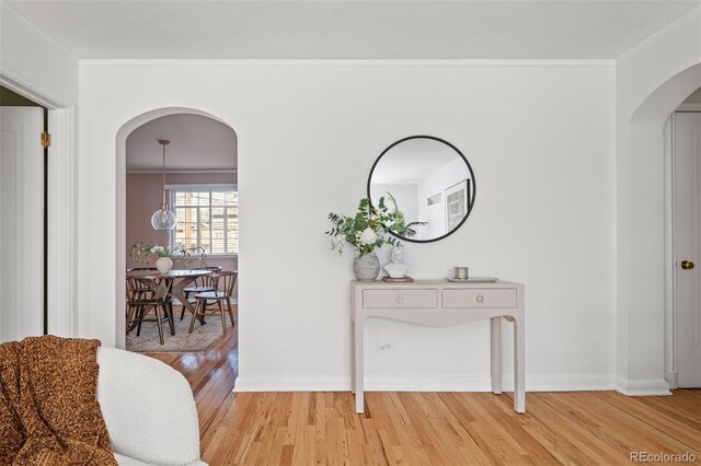 1410 Vine St Unit 3, Denver, CO 80206 - corridor featuring arched walkways, light wood-style floors, baseboards, and ornamental molding