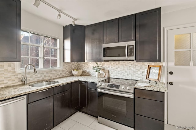 1410 Vine St Unit 3, Denver, CO 80206 - kitchen featuring appliances with stainless steel finishes, a sink, light stone counters, backsplash, and light tile patterned floors