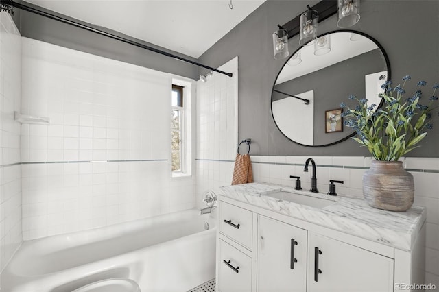 1410 Vine St Unit 3, Denver, CO 80206 - bathroom with tile walls, washtub / shower combination, vanity, and a wainscoted wall
