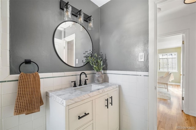 1410 Vine St Unit 3, Denver, CO 80206 - bathroom with tile walls, vanity, wood finished floors, and wainscoting