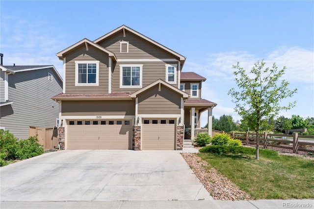 craftsman house with fence, an attached garage, concrete driveway, covered porch, and stone siding