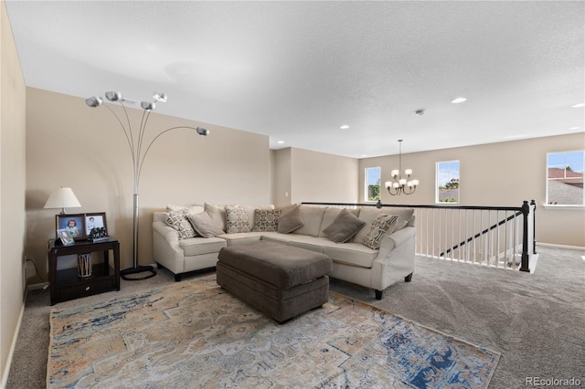 carpeted living room with a chandelier, recessed lighting, baseboards, and a textured ceiling