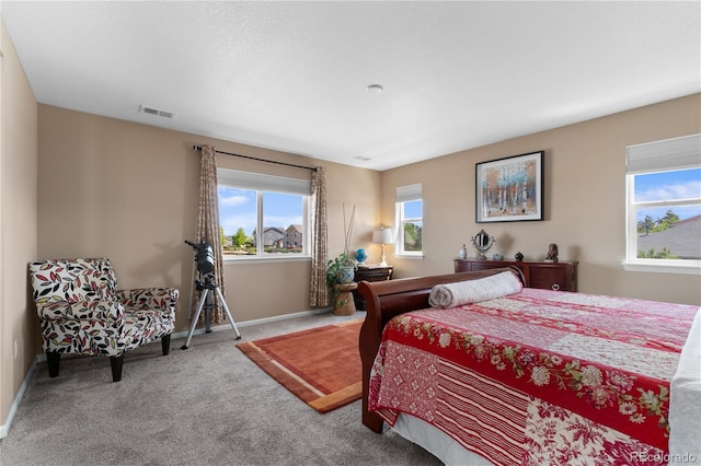 bedroom with carpet floors and baseboards