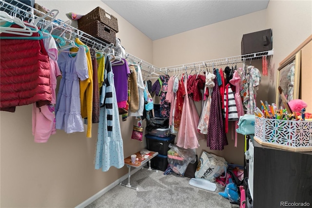 walk in closet with carpet floors