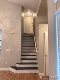 6973 Summerset Ave, Longmont, CO 80504 - stairs with baseboards and wood finished floors