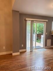 6973 Summerset Ave, Longmont, CO 80504 - empty room with wood finished floors and baseboards