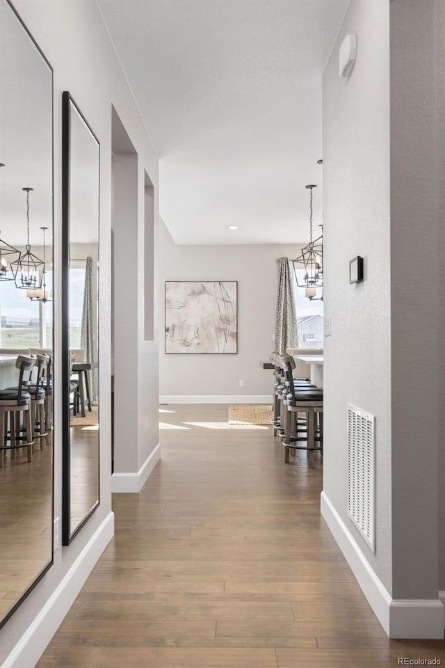 15608 E Otero Cir, Centennial, CO 80112 - corridor with a chandelier, baseboards, and wood finished floors