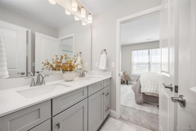 15608 E Otero Cir, Centennial, CO 80112 - ensuite bathroom featuring double vanity and baseboards