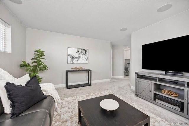 15608 E Otero Cir, Centennial, CO 80112 - living area featuring washer / dryer, light colored carpet, and baseboards